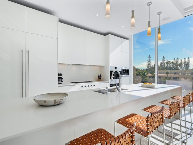 4651 Gulf Of Mexico Dr Unit 402, Longboat Key, FL 34228 - kitchen featuring modern cabinets, a breakfast bar area, pendant lighting, stovetop, and recessed lighting