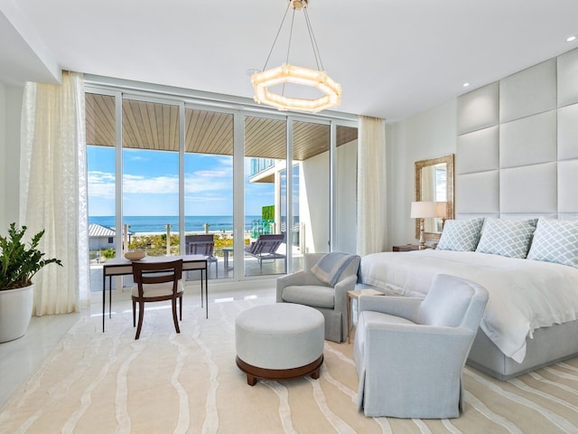 4651 Gulf Of Mexico Dr Unit 402, Longboat Key, FL 34228 - bedroom with a wall of windows, access to outside, a water view, and a chandelier