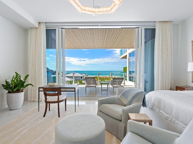 bedroom with access to outside, a water view, and multiple windows