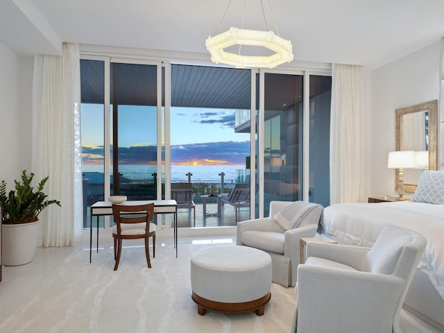 bedroom featuring access to outside, multiple windows, and an inviting chandelier