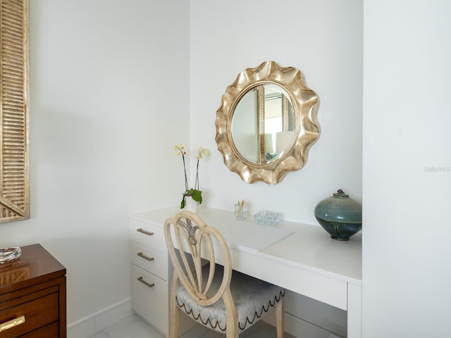 home office with built in desk and light tile patterned floors