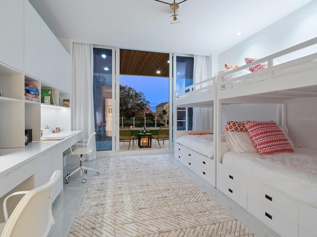 bedroom with access to outside, multiple windows, built in desk, and light tile patterned floors