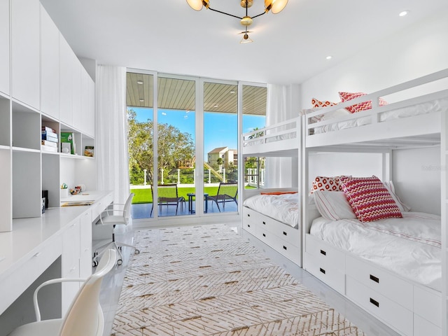 bedroom with access to outside, light hardwood / wood-style floors, and built in desk