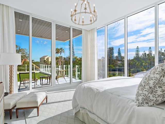 4651 Gulf Of Mexico Dr Unit 402, Longboat Key, FL 34228 - bedroom with access to outside, a chandelier, and floor to ceiling windows