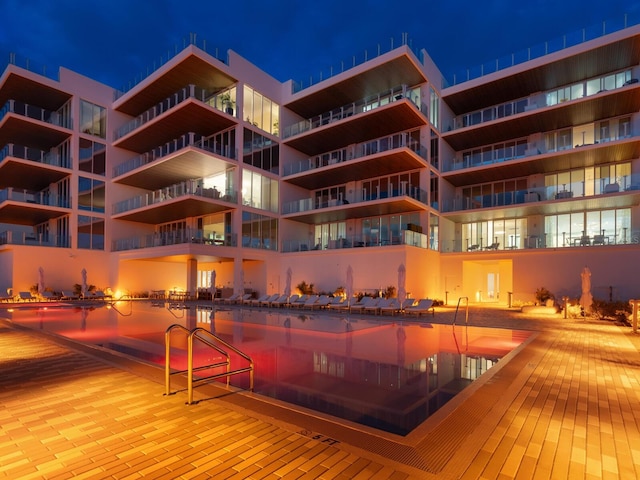 view of pool at twilight