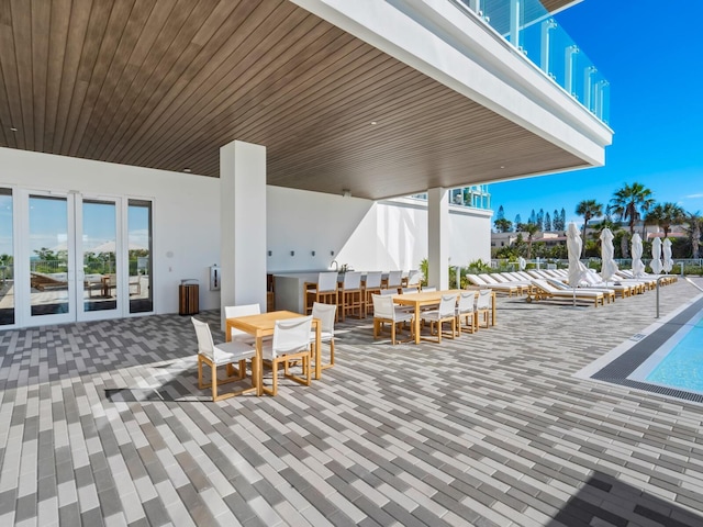 4651 Gulf Of Mexico Dr Unit 402, Longboat Key, FL 34228 - view of patio / terrace featuring a swimming pool and outdoor dining area