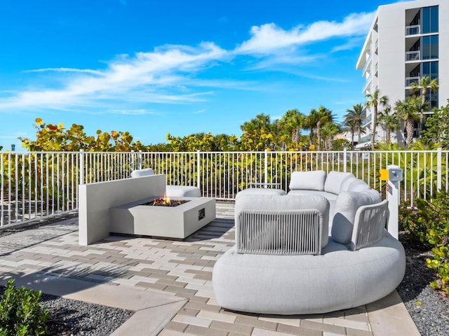 view of patio / terrace featuring an outdoor living space with a fire pit