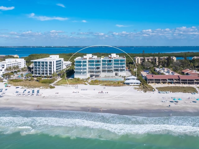 birds eye view of property featuring a beach view and a water view