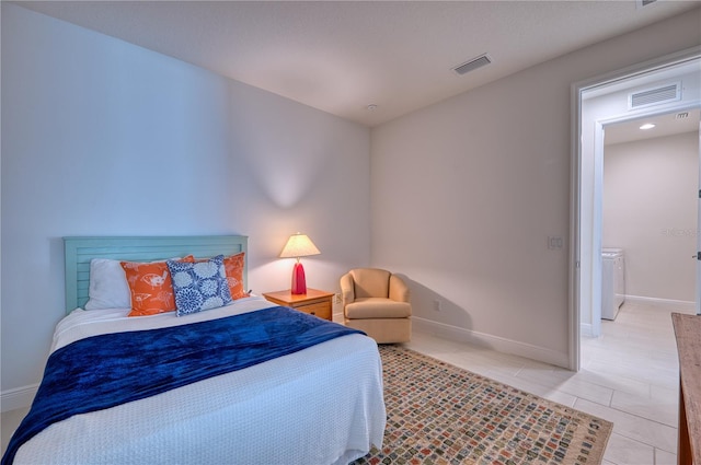 bedroom with visible vents, baseboards, and light tile patterned floors