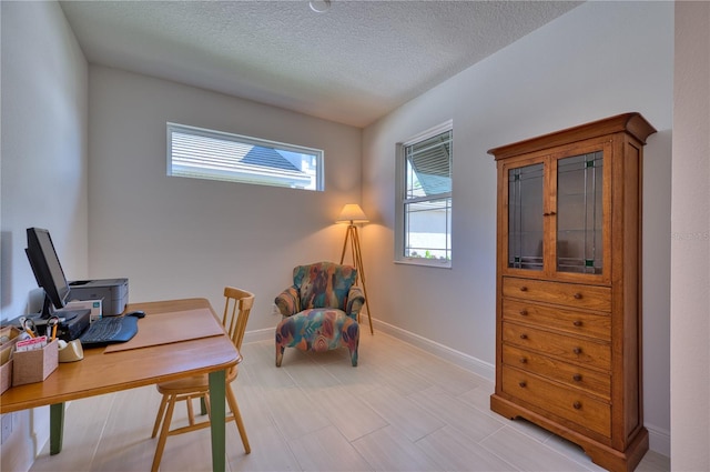 office featuring a textured ceiling and baseboards