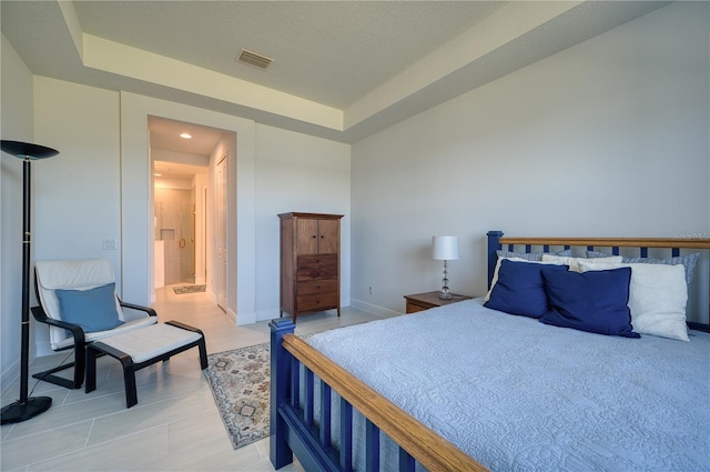 bedroom with baseboards and visible vents