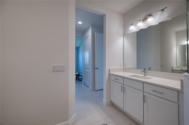 bathroom with vanity and baseboards