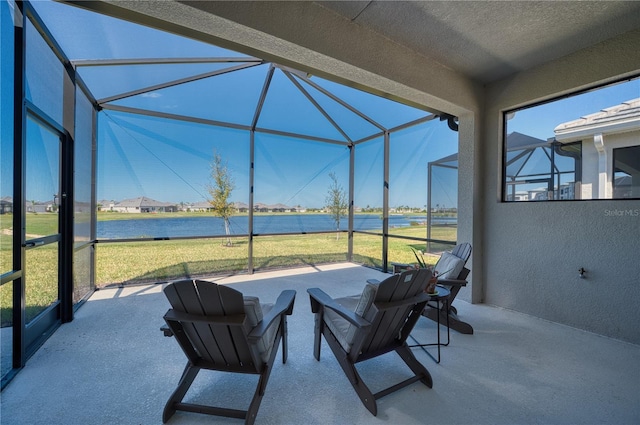 view of patio / terrace with a lanai and a water view