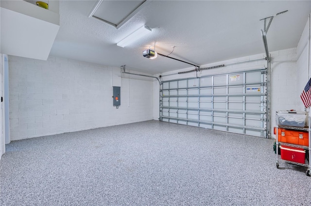 garage featuring a garage door opener, concrete block wall, and electric panel