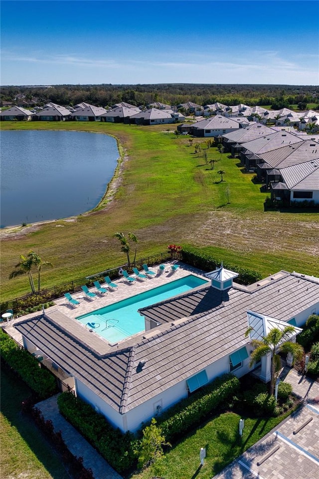 drone / aerial view featuring a water view and a residential view