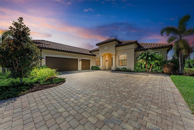 mediterranean / spanish house featuring a garage