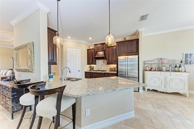 kitchen featuring custom range hood, stainless steel appliances, sink, crown molding, and tasteful backsplash