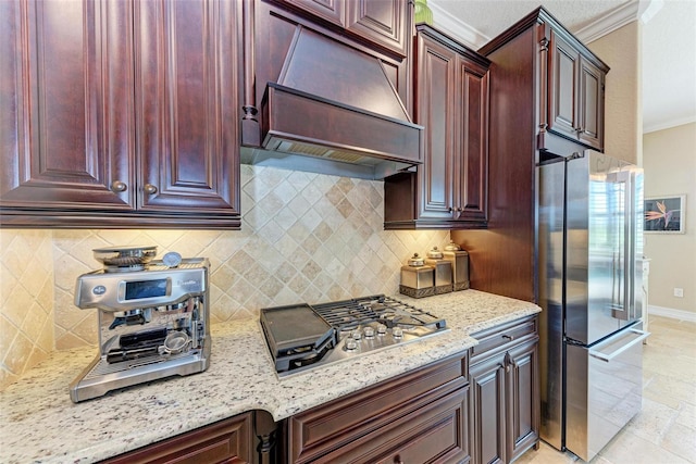 kitchen with light stone countertops, crown molding, appliances with stainless steel finishes, and custom range hood