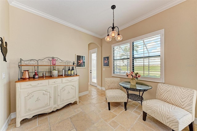 sitting room featuring ornamental molding and a chandelier