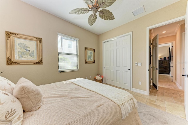 bedroom with a closet, ceiling fan, and ornamental molding