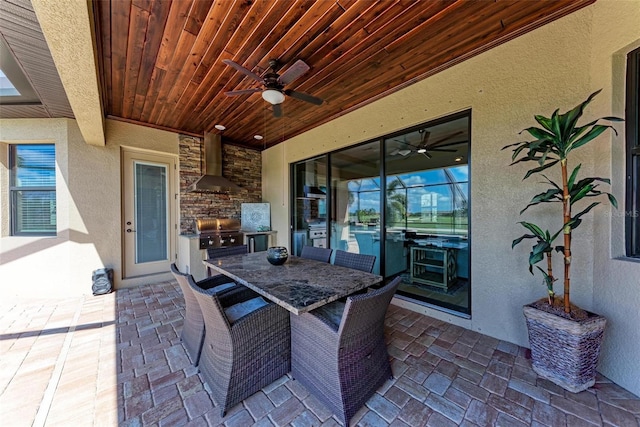 view of patio / terrace featuring ceiling fan, grilling area, and exterior kitchen