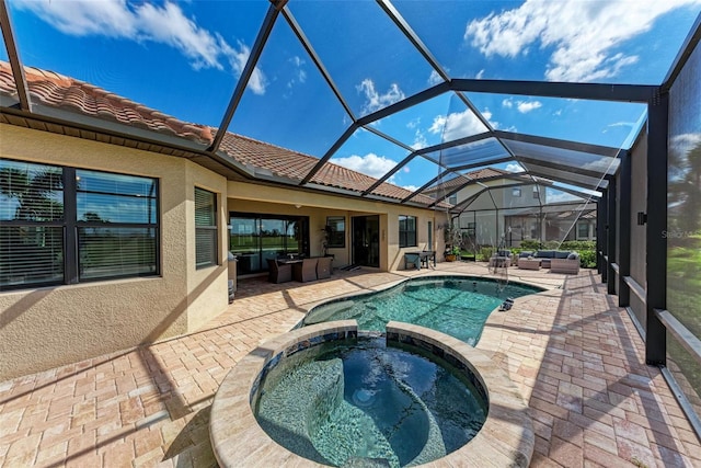 view of swimming pool featuring a patio area, a lanai, and an in ground hot tub