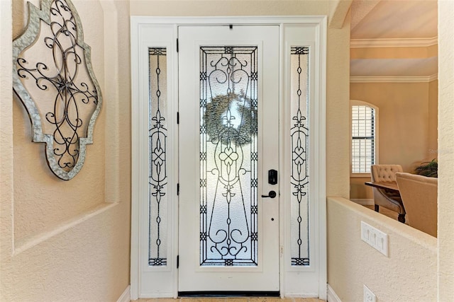 foyer entrance featuring crown molding