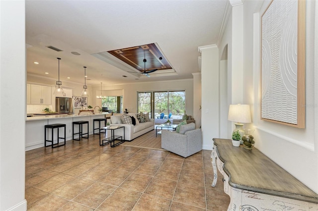 living room featuring light tile patterned floors, decorative columns, ceiling fan, and ornamental molding