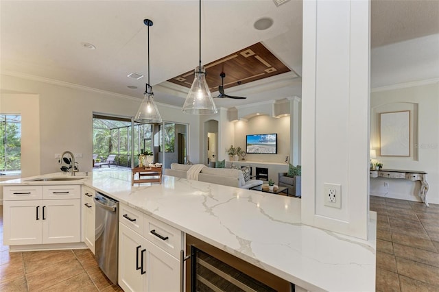 kitchen with dishwasher, sink, hanging light fixtures, wine cooler, and light stone counters