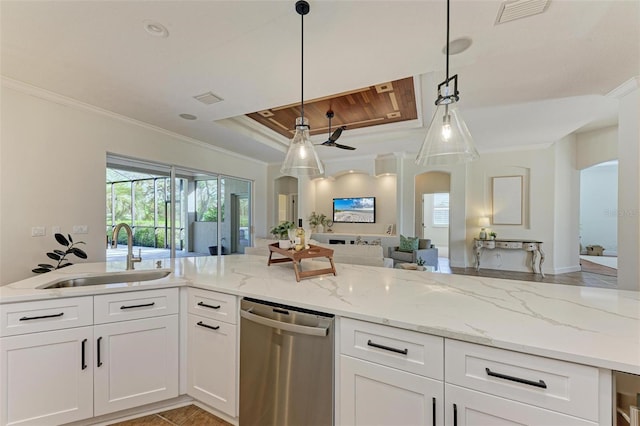 kitchen featuring stainless steel dishwasher, decorative light fixtures, light stone counters, and sink