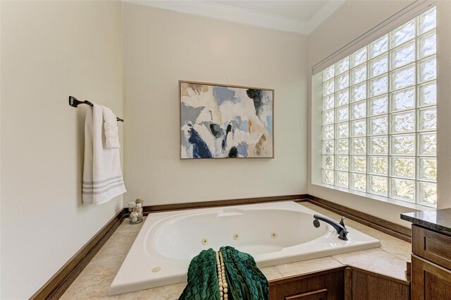 bathroom featuring a tub, a wealth of natural light, crown molding, and vanity