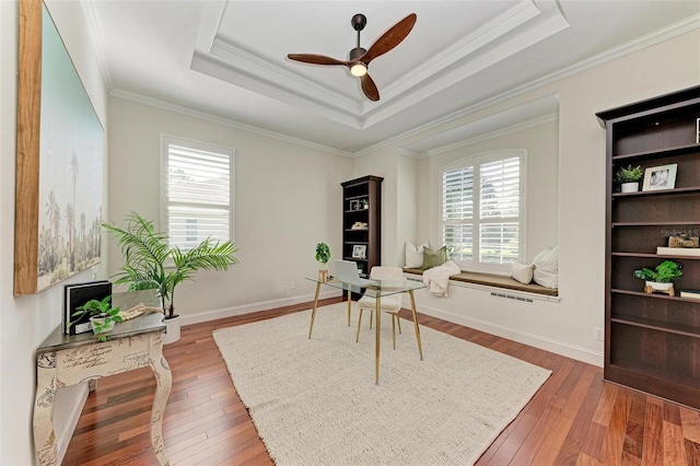 office area with a wealth of natural light, crown molding, ceiling fan, and dark wood-type flooring