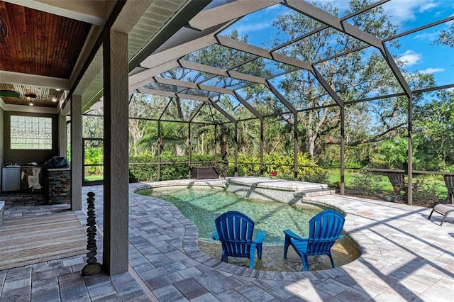 view of patio with a lanai and an outdoor kitchen