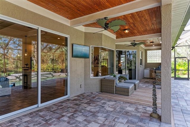 view of patio / terrace with area for grilling, ceiling fan, and a lanai