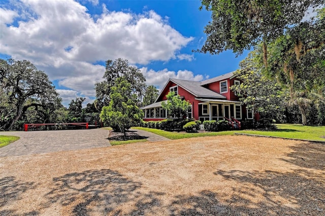 exterior space with a sunroom and a front yard