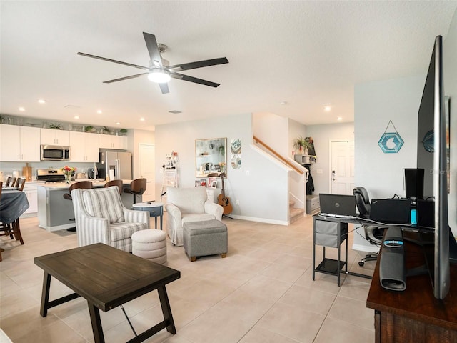 tiled living room with ceiling fan and a textured ceiling