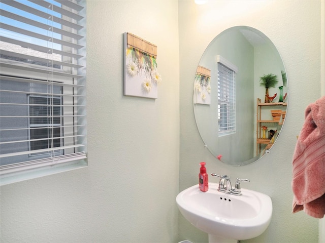 bathroom featuring a wealth of natural light and sink