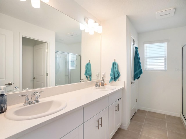 bathroom featuring vanity, tile patterned flooring, and a shower with shower door