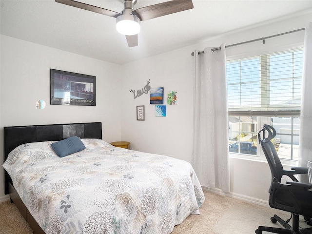 bedroom with light carpet and ceiling fan