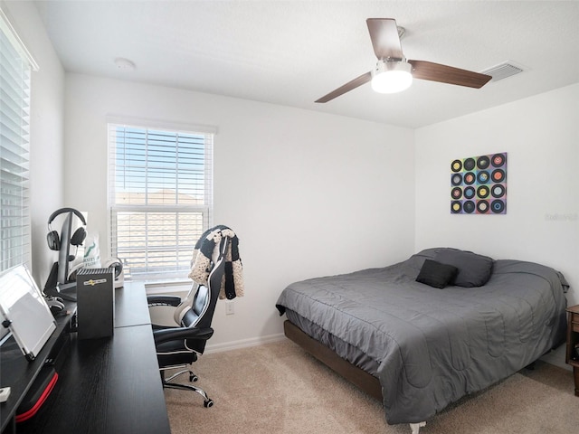 bedroom with light carpet and ceiling fan