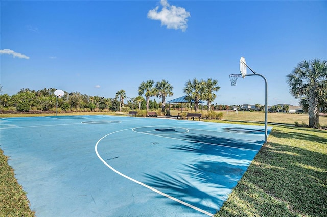 view of sport court featuring a lawn and a gazebo