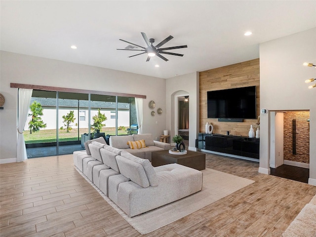 living room with ceiling fan and light hardwood / wood-style floors