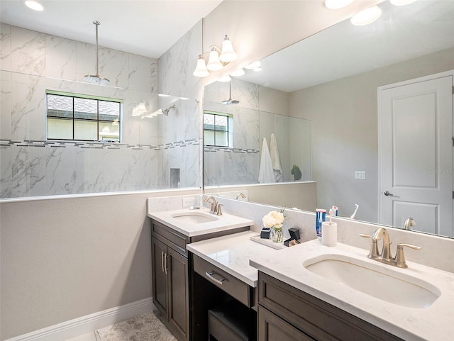 bathroom with vanity and a tile shower