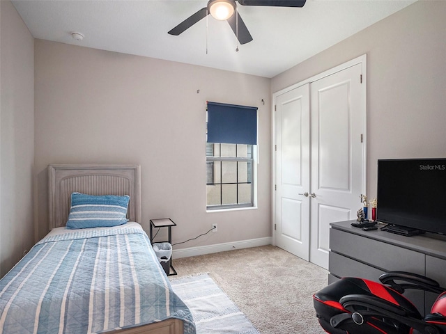 carpeted bedroom with a closet and ceiling fan