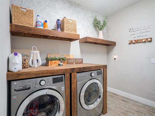 laundry room featuring light wood-type flooring and washing machine and clothes dryer