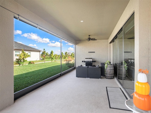 sunroom with ceiling fan and plenty of natural light