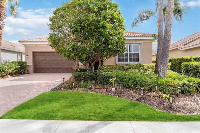 view of front of property with a front yard and a garage