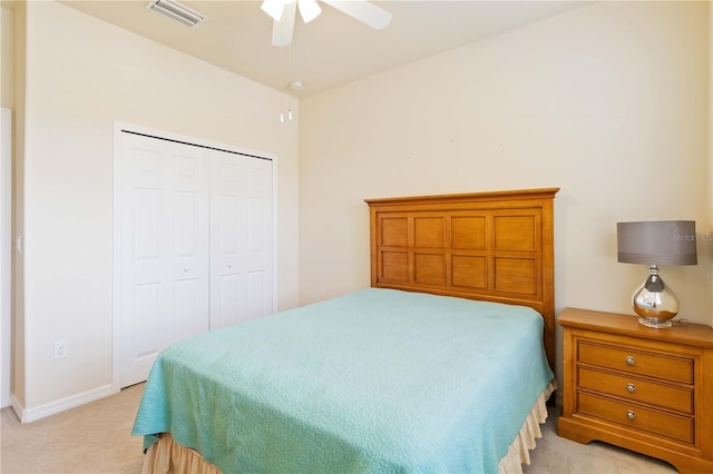 carpeted bedroom featuring ceiling fan and a closet