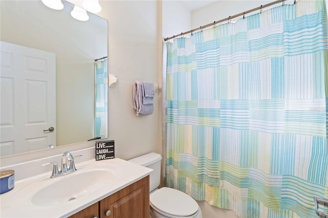 bathroom featuring toilet and vanity