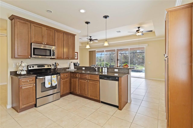 kitchen featuring ceiling fan, appliances with stainless steel finishes, kitchen peninsula, and sink